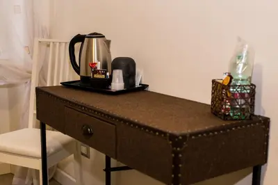 a table with a coffee maker on top of it at Mikasa Piazza Bologna in Rome