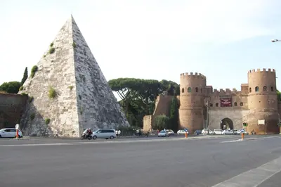 a castle with a pyramid in front of a street at Modern Apartment near Colosseum in Rome