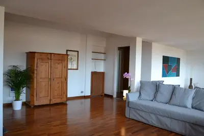 a living room with a couch and a wooden floor at Penthouse Cardello Colosseum in Rome
