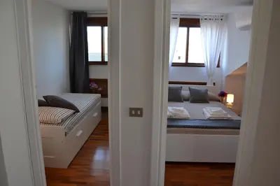 a small bedroom with a bed and a window at Penthouse Cardello Colosseum in Rome