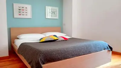 a bed with two pillows on it in a bedroom at La Controra Guesthouse Roma in Rome