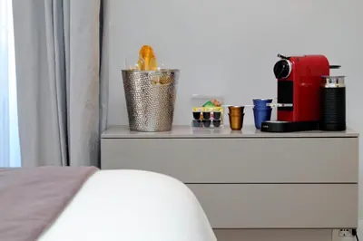 a bedroom with a dresser with a coffee maker on it at Propaganda Suites in Rome