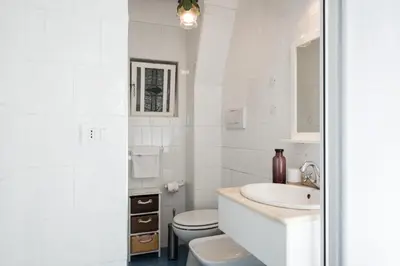 a white bathroom with a sink and a toilet at Al Cedro in Rome