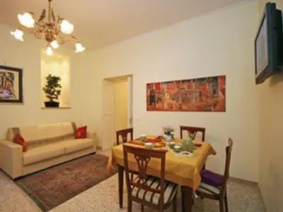 a living room with a table and a couch at Frattina De Luxe in Rome