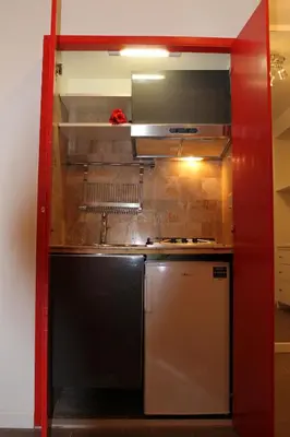a small kitchen with a sink and a refrigerator at Mama Trastevere in Rome