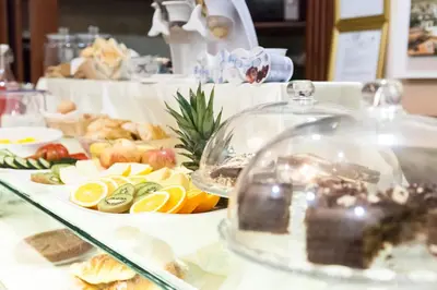 a buffet with fruits and vegetables on a table at Hotel Suite Caesar in Rome