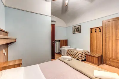 a bedroom with two beds and a door in it at Hotel Altavilla in Rome