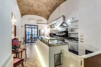 a kitchen with white walls and a ceiling at Hotel Altavilla in Rome