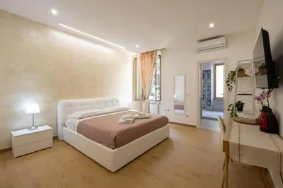 a bedroom with a bed and a table and a desk at San Pietro Roma Suite in Rome