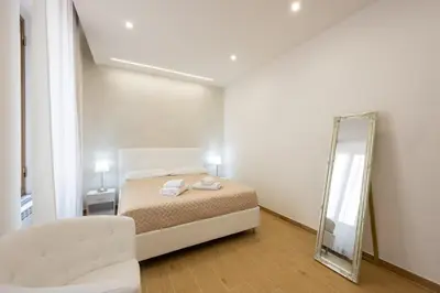 a bedroom with a bed and a mirror at San Pietro Roma Suite in Rome