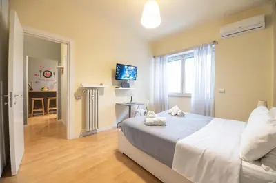 a bedroom with a bed and a television in it at Le Piazze di Roma Sweet Apartment in Rome