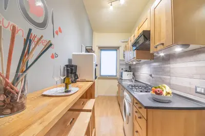 a kitchen with a counter with a bowl of fruit at Le Piazze di Roma Sweet Apartment in Rome