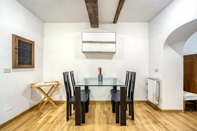 a dining room with a glass table and chairs at Deluxe Apartment - Campo dei Fiori in Rome