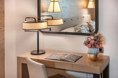 a desk with two lamps and a mirror at Starhotels Metropole in Rome
