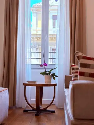 a living room with a table and a window at 900 Piazza del Popolo in Rome