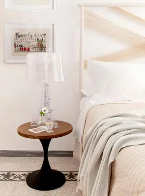 a bedroom with a bed and a table with a lamp at Modern Comfort, Poetic Charm in Rome