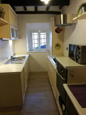 a kitchen with a sink and a stove at Lo Chalet di Trastevere in Rome