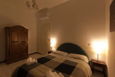 a bedroom with a bed with a checkered blanket at BoRooms in Rome