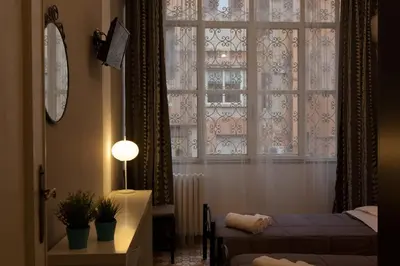 a bedroom with a window and a bed and a table at BoRooms in Rome