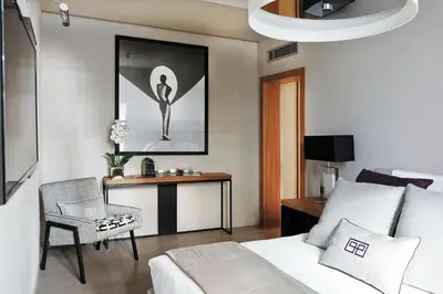 a bedroom with a bed and a desk with a laptop at Parioli Place B&B in Rome