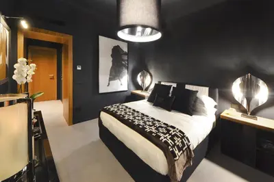 a bedroom with a bed and a black wall at Parioli Place B&B in Rome
