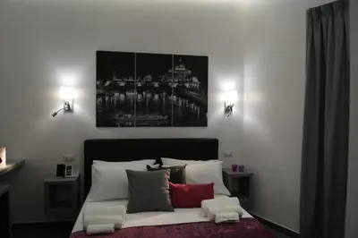a bedroom with a bed with a picture on the wall at Room 91-S. Peter in Rome