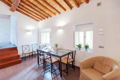 a living room with a dining room table and chairs at Domizio in Rome