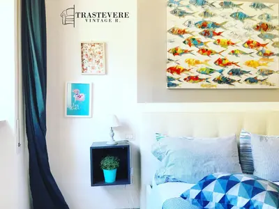 a bedroom with a bed and a painting on the wall at Trastevere Vintage Rosazza in Rome