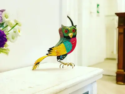a colorful bird statue sitting on top of a table at Trastevere Vintage Rosazza in Rome
