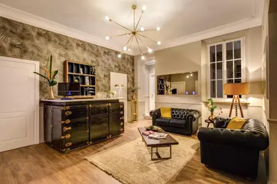 a living room with a couch and a table at Charme Spagna Boutique Hotel in Rome