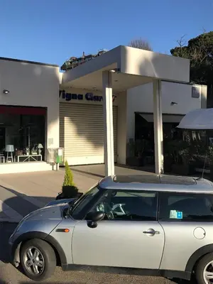 a white car parked in front of a store at Emilio's Home in Rome