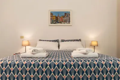 a bedroom with a bed with towels on it at Casa dell'Arco - WelcomeToRhome in Rome