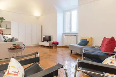 a living room with two couches and a tv at Casa dell'Arco - WelcomeToRhome in Rome