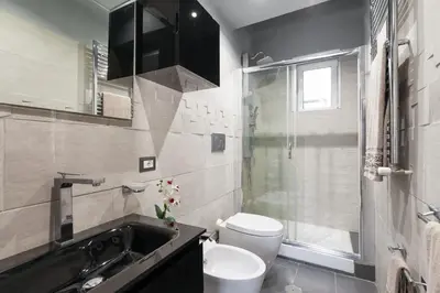 a bathroom with a toilet and a sink and a shower at Home Domus Borgo Pio - San Pietro in Rome