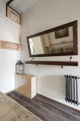a mirror on the wall in a room at Home Domus Borgo Pio - San Pietro in Rome