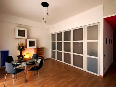 a dining room with a glass table and chairs at Casa Vacanze Shivon in Rome