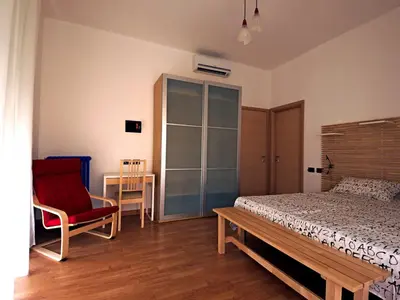 a bedroom with a bed and a chair and a table at Casa Vacanze Shivon in Rome