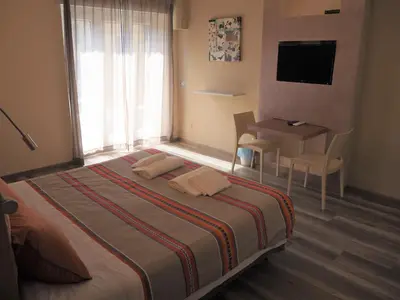a bedroom with a bed and a desk and a television at Bed and Breakfast New Morning Holiday in Rome