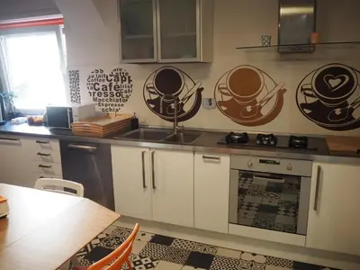 a kitchen with white cabinets and a stove top oven at Bed and Breakfast New Morning Holiday in Rome
