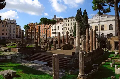 a group of ancient ruins in a city with buildings at Hotel Barrett in Rome