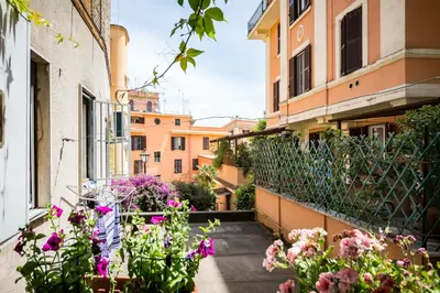 a balcony with flowers on a building at Studio via Nicola Fabrizi in Rome