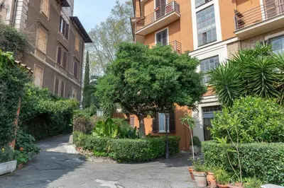 an apartment building with a tree in a courtyard at Studio via Nicola Fabrizi in Rome