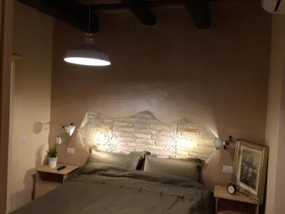 a bedroom with a bed and a brick wall at Trans Tiberim in Rome