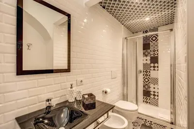 a bathroom with a sink and a toilet and a mirror at Pantheon Miracle Suite in Rome