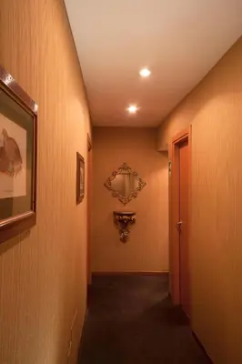 a hallway with wood paneled walls and a hallway with a door at Orange Garden Guest House in Rome