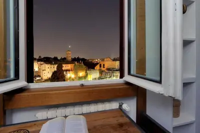 a window with a view of a city at Fori Imperiali Apartment in Rome