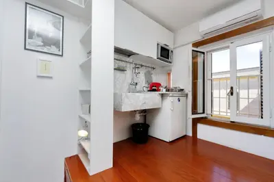 a kitchen with a sink in a room with a window at Fori Imperiali Apartment in Rome