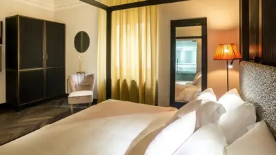 a hotel room with a bed and a mirror at Hotel The Haven Roma in Rome