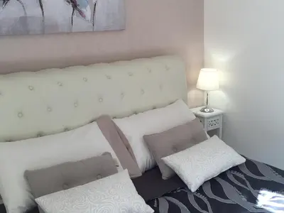 a white bed with two pillows on top of it at Saint Peter Cozy Apartment in Rome