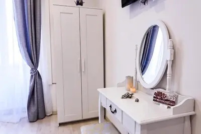 a dressing room with a mirror and a dresser at Saint Peter Cozy Apartment in Rome